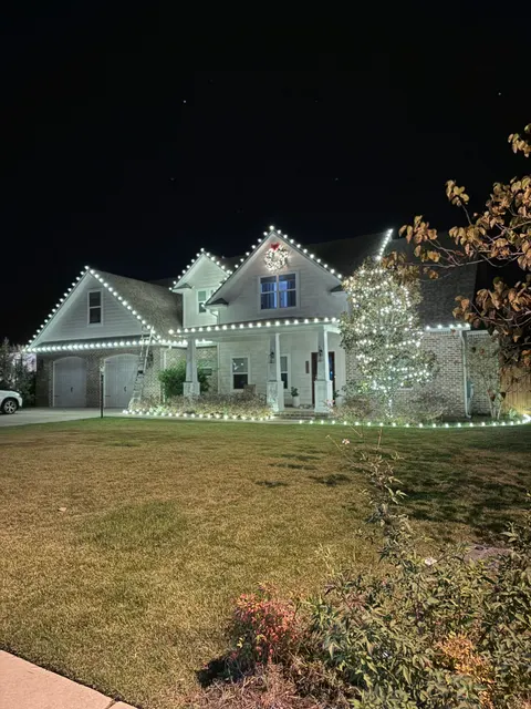 Holiday lighting around a home and front lawn