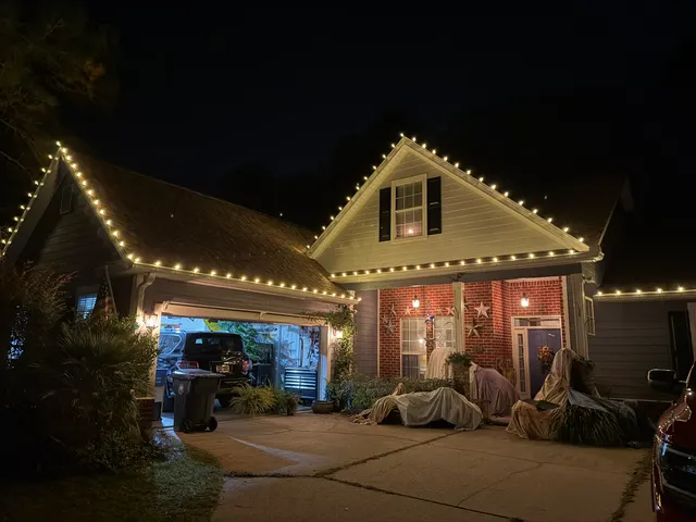 Holiday lights tracing a garage and front porch roofline