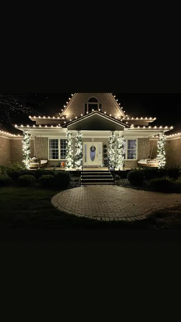 Christmas lighting framing the roof and front entrance