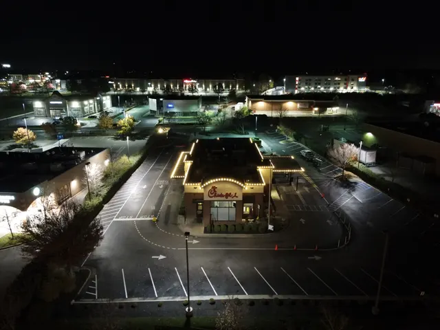 Aerial view of a commercial Christmas roofline display and parking area