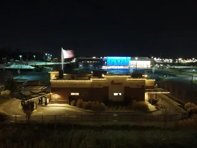 Nighttime view of a commercial property outlined in Christmas lights