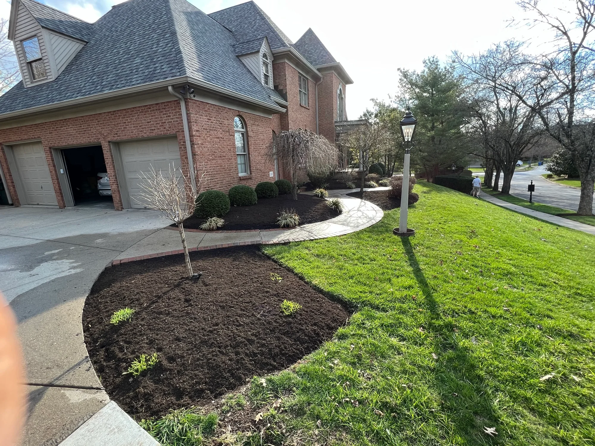 Fresh mulch and planting beds along a front walkway