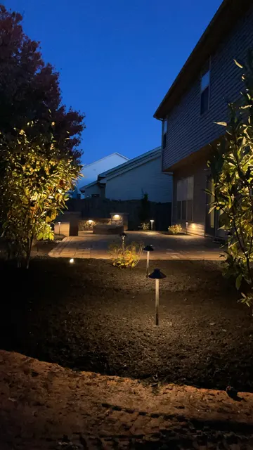 Low landscape lights beside a home at dusk