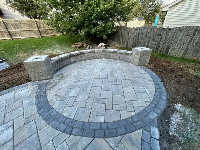 Circular paver inset with a curved seating wall and columns
