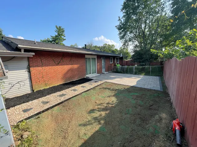 Finished rectangular patio beside a brick home