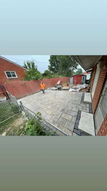 Overhead view of patio work beside a brick home