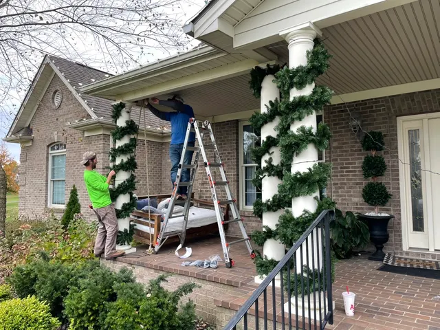 Installation of Christmas garland around porch columns