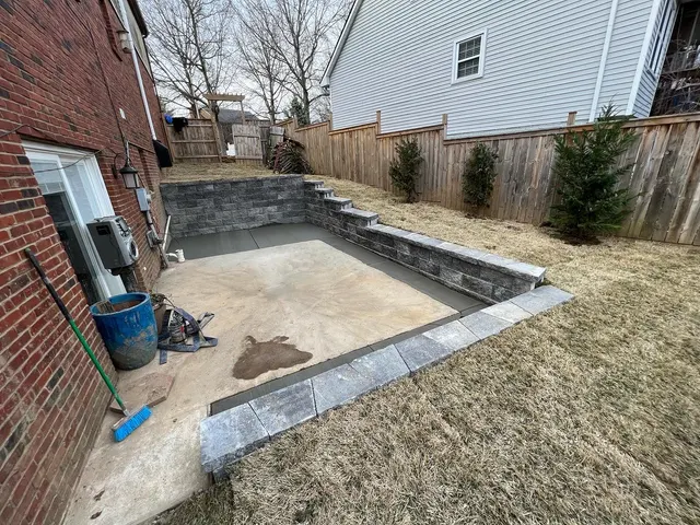 Retaining walls enclosing a patio base beside a home