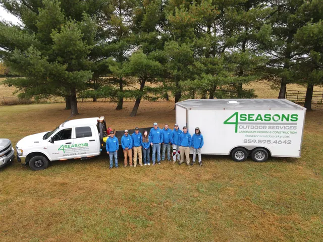 Company truck, trailer and crew at an outdoor job site