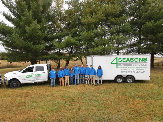 Group photograph of the 4 Seasons crew beside their trailer